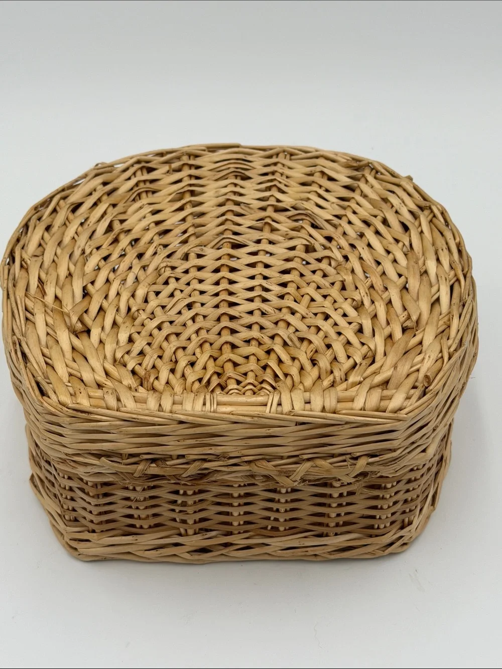 A Cute, charming vintage shell-shaped rattan storage basket with a front handle.